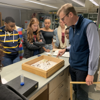 Professor Lundquist showing examples of pinned insects for NYC103: New York City Urban Ecosystem