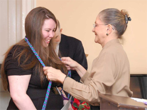 Twila Ligget, Ph.D., presents honors cords to a student during the Kappa Delta Pi Honor Society i...
